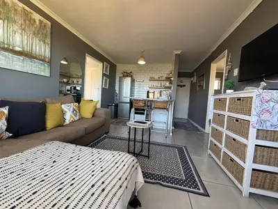 a living room with a couch and a table at #FiftySeven in Hermanus
