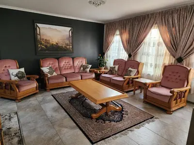 a living room with chairs and a table at Cape Town gem 