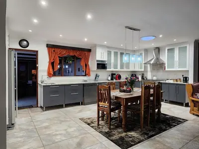 a kitchen with a table and chairs in a kitchen at Cape Town gem 