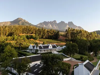 an aerial view of a house with mountains in the background at The Doolhof Country House in Wellington