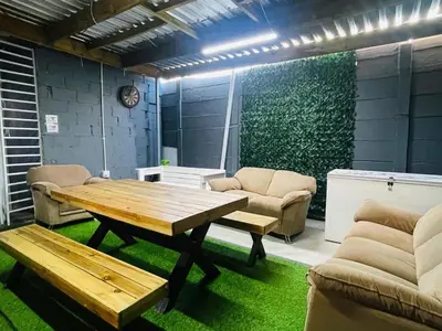 a living room with a wooden table and chairs at 57onWYNNE in Cape Town