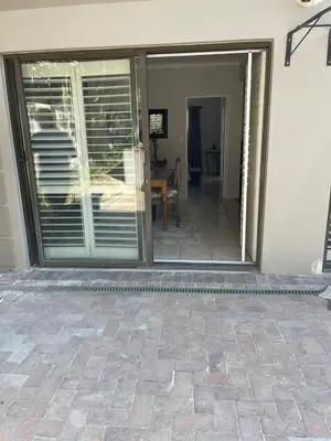 a sliding glass door leading to a patio at Sophia’s Cottage in Cape Town