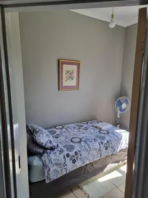 a bedroom with a bed in a room at Strawberry fields Tranquility in Cape Town