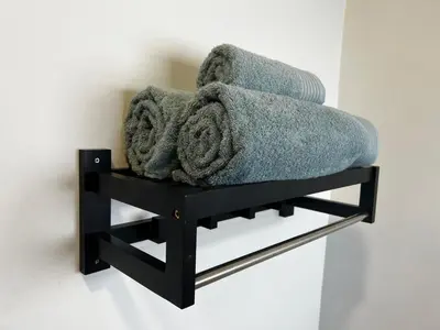 a towel rack with towels and towels on a wall at the Vine in Cape Town