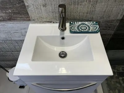 a white sink with a phone sitting on top of it at the Vine in Cape Town