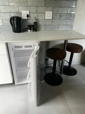 a kitchen with a counter with two stools under it at the Vine in Cape Town