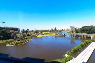 a view of a river with a bridge at Modern apartment in Century City in Cape Town