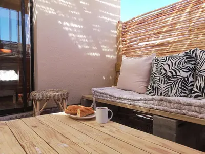 a table with a plate of food and a couch at Coastal Cozy 2 in Cape Town
