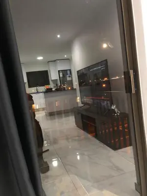 a view of a living room with a television and a kitchen at Comfort and Style in Cape Town