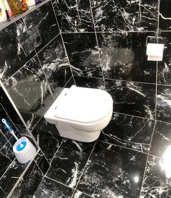 a bathroom with a toilet in a black tiled wall at Comfort and Style in Cape Town