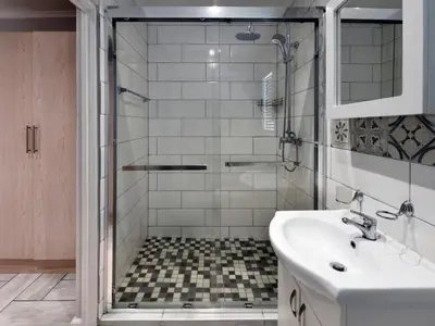 a bathroom with a shower and a sink at La Rochelle Cottage in Franschhoek