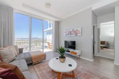 a living room with a couch and a table at Horizon Bay 1603 by HMH in Cape Town