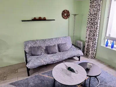 a living room with a couch and a table at Amatoni green apartment in Stellenbosch