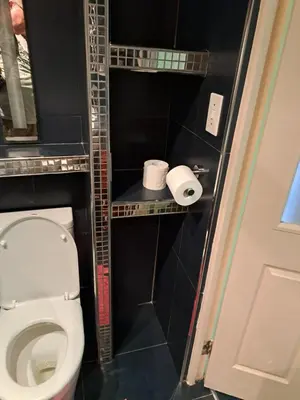 a bathroom with a toilet and two rolls of toilet paper at Amatoni green apartment in Stellenbosch
