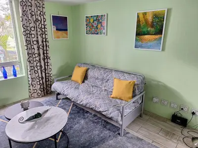 a living room with a couch and a table at Amatoni green apartment in Stellenbosch