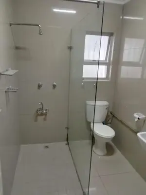 a bathroom with a toilet and a shower and a sink at Harmony Lawson Road in Cape Town