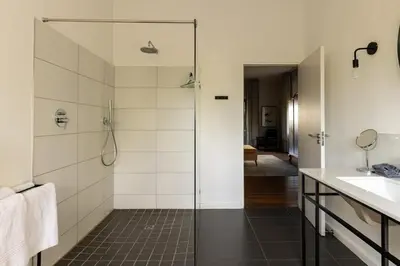 a bathroom with a shower and a sink at Fransmanskraal Accommodation - Luxury Stellenbosch Farm Villa in Stellenbosch