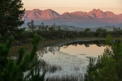 a view of a river with mountains in the background at Fransmanskraal Accommodation - Luxury Stellenbosch Farm Villa in Stellenbosch