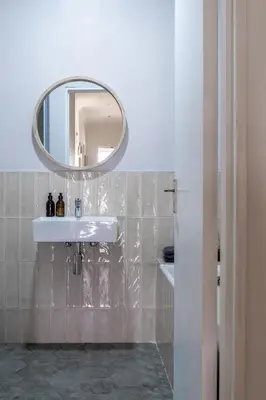 a bathroom with a white sink and a mirror at Newly Renovated - Stellenbosch Farm Cottage in Stellenbosch