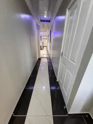 a hallway with a white door and a black tile floor at Essential Lodge23 in Cape Town