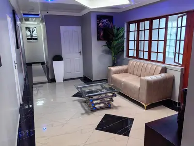 a living room with a couch and a glass table at Essential Lodge23 in Cape Town