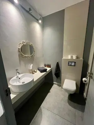 a bathroom with a sink and a toilet and a mirror at Stay on Main 1 in Paarl
