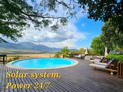a pool on a deck with a view of the mountains at Valley View Eco Country Estate - Paradise in the Winelands in Villiersdorp
