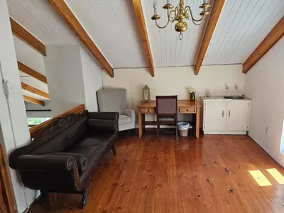 a living room with a couch and a table at Valley View Eco Country Estate - Paradise in the Winelands in Villiersdorp
