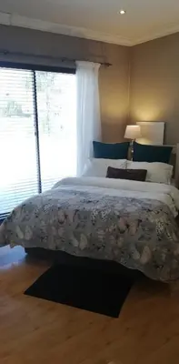 a bedroom with a large bed and a large window at Durbanville Luxury Living Private Room in Durbanville