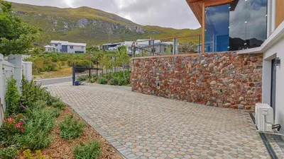 a stone walkway in front of a house at The View, Studio in Hermanus