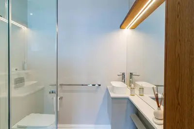 a bathroom with a glass shower and a sink at The View, Studio in Hermanus