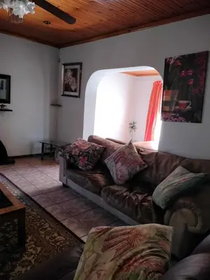 a living room with a couch and a lamp at Near Grandwest in Cape Town