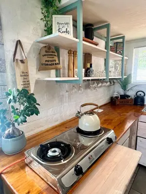 a kitchen with a stove with a tea kettle on it at Seaview on 2822 Happy Whale Cottage in Bettyʼs Bay