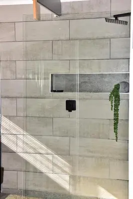 a glass wall in a building with a plant at Seaview on 2822 Happy Whale Cottage in Bettyʼs Bay