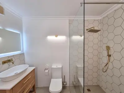 a bathroom with a toilet and a glass shower at 2 Barford Haven in Hermanus