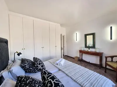 a bedroom with two beds with pillows and a mirror at 2 Barford Haven in Hermanus