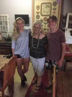 three people posing for a picture in a room at Suzies Huis Restaurant Bed and Breakfast in Cape Town
