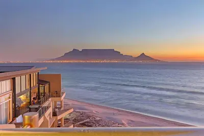 a view of the ocean with table mountain in the background at Horizon Bay 1201 in Bloubergstrand