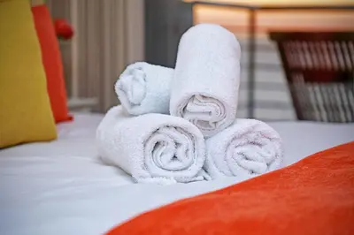 a pile of towels sitting on top of a bed at Horizon Bay 1201 in Bloubergstrand