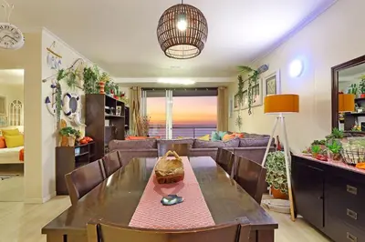 a living room with a table and a couch at Horizon Bay 1201 in Bloubergstrand