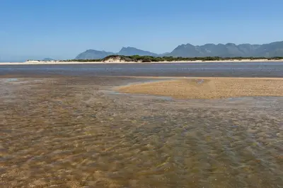 a large body of water with mountains in the background at The Blue Cabin in Fisherhaven