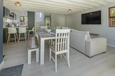 a kitchen and living room with a table and a couch at The Blue Cabin in Fisherhaven