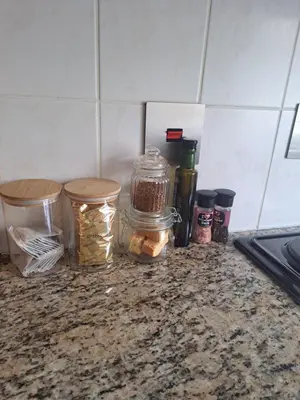 a kitchen counter with jars of food on it at Pearlmar Views in Cape Town