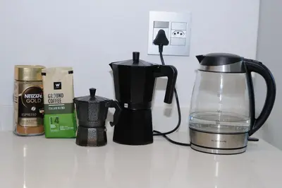 a coffee maker and a jug of water on a counter at Oranje Meul in Paarl