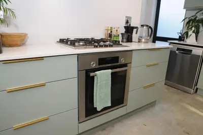 a kitchen with a stove with a towel on the oven at Oranje Meul in Paarl