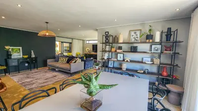 a living room with a table and a couch at House of Anjel in Suider-Paarl