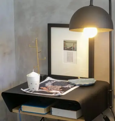 a table with a lamp and books on a bed at House of Anjel in Suider-Paarl