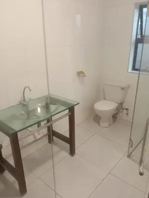 a bathroom with a glass sink and a toilet at Cape Town 5 bedroom house Belhar in Cape Town