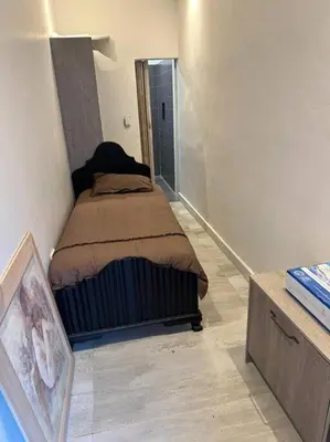 a small bedroom with a bed in a room at Lemon House Modern duplex by UCT in Cape Town