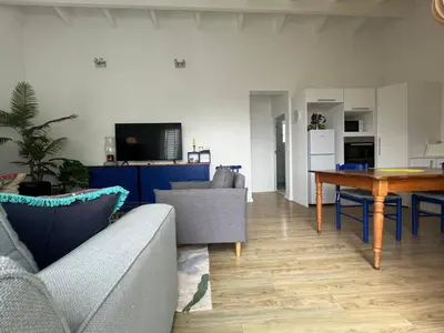 a living room with a couch and a table at Sunset Starfish Apartment in Cape Town